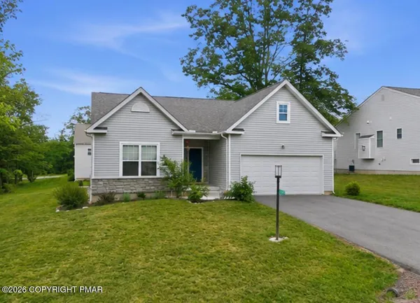 a front view of house with yard and green space