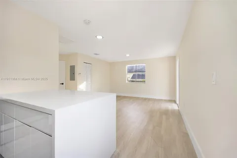 a view of a kitchen with a sink and a refrigerator