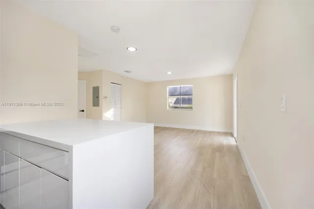 a view of a kitchen with a sink and a refrigerator