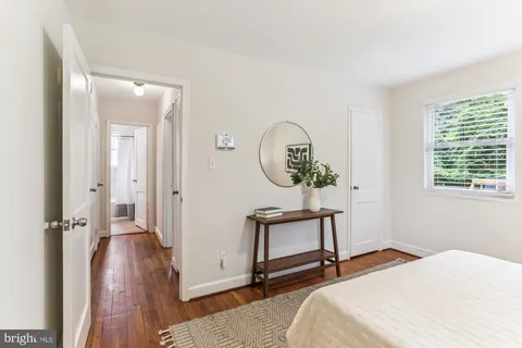 a bedroom with a bed and a mirror