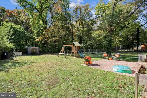 a backyard of a house with table and chairs