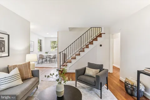 a living room with furniture and a dining table