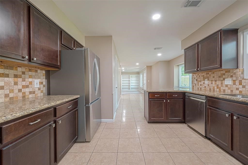 6534 Bayonne Drive Spring, TX 77389 - Photo 5 of 15 a kitchen with a sink and a refrigerator