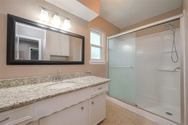 a bathroom with a granite countertop sink mirror and double