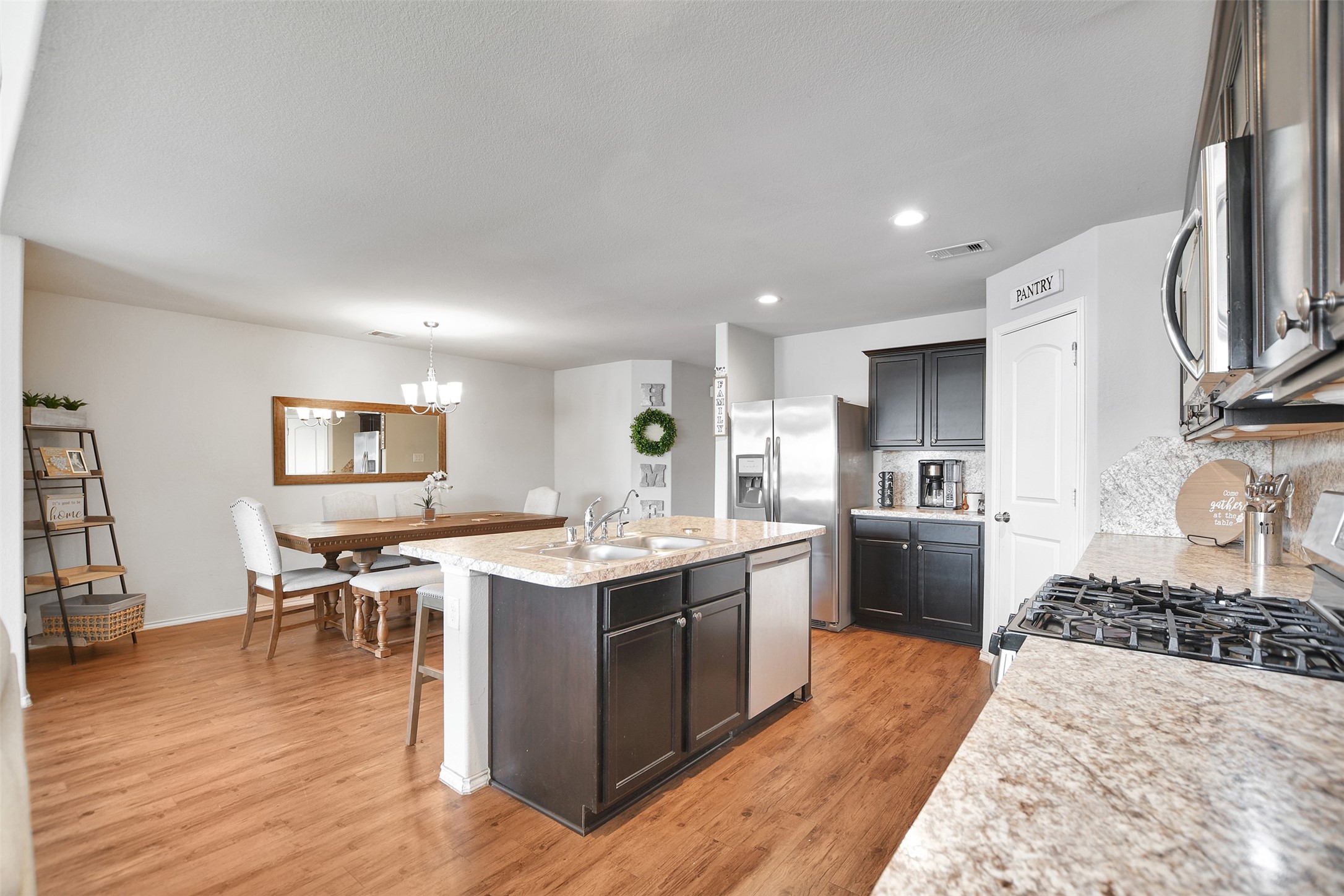 1022 Rancho Grande Drive Channelview, TX 77530 - Photo 13 of 36 a kitchen with a sink stove and wooden cabinets