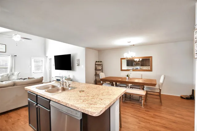 a room with a table chairs and a flat screen tv