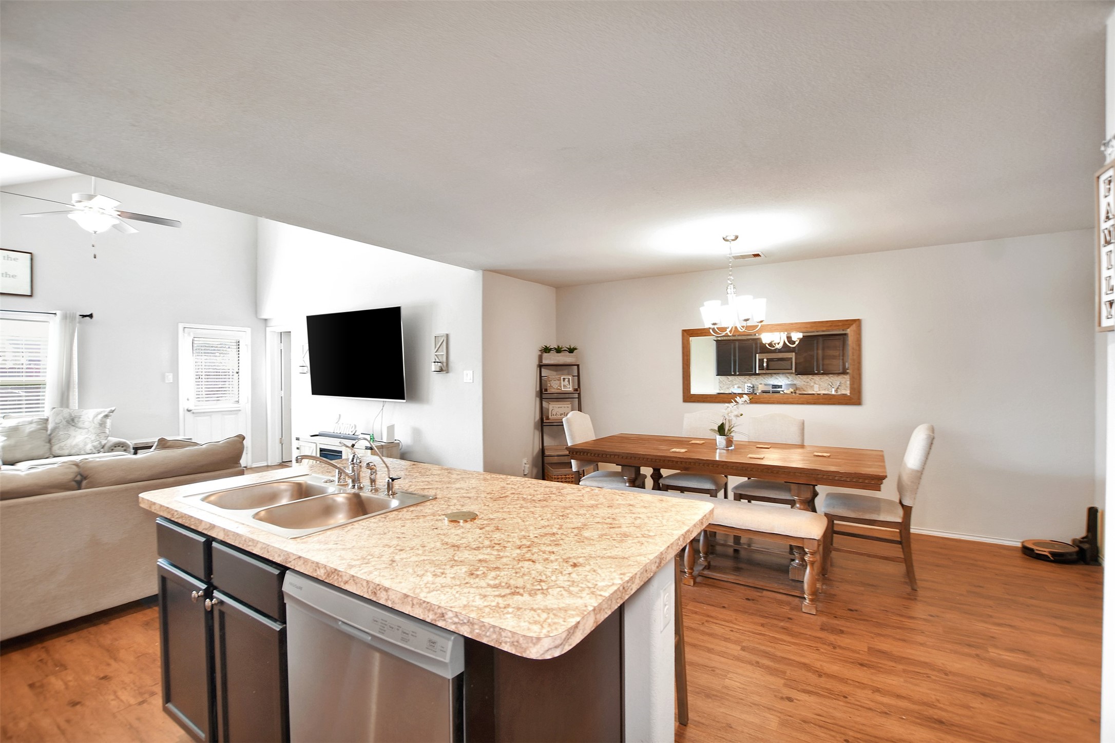 1022 Rancho Grande Drive Channelview, TX 77530 - Photo 15 of 36 a room with a table chairs and a flat screen tv