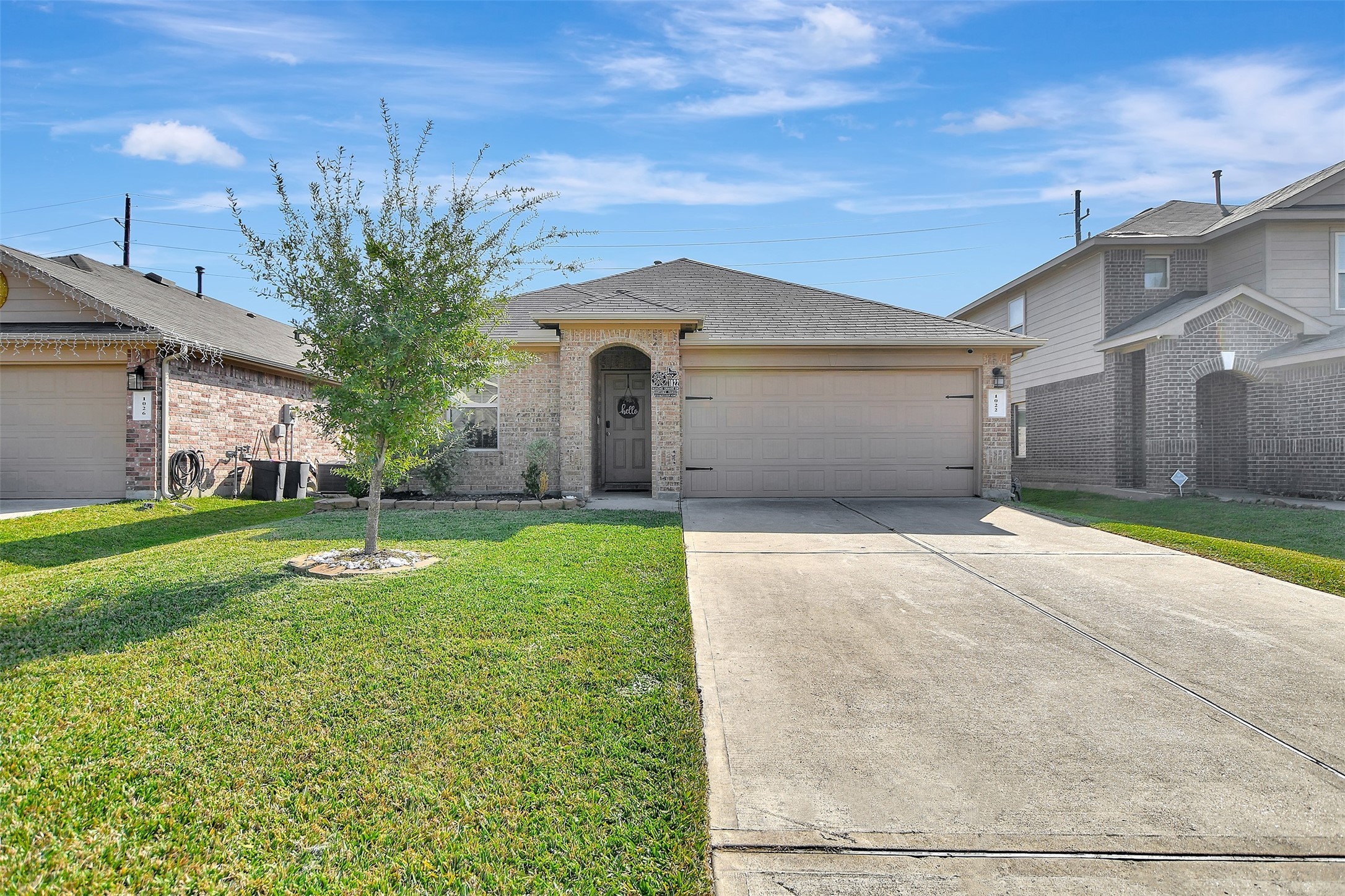 1022 Rancho Grande Drive Channelview, TX 77530 - Photo 2 of 36 a front view of a house with a yard and garage
