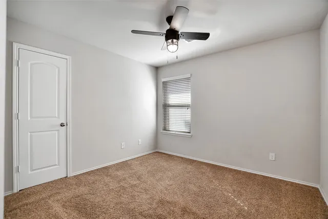 a view of an empty room and a window