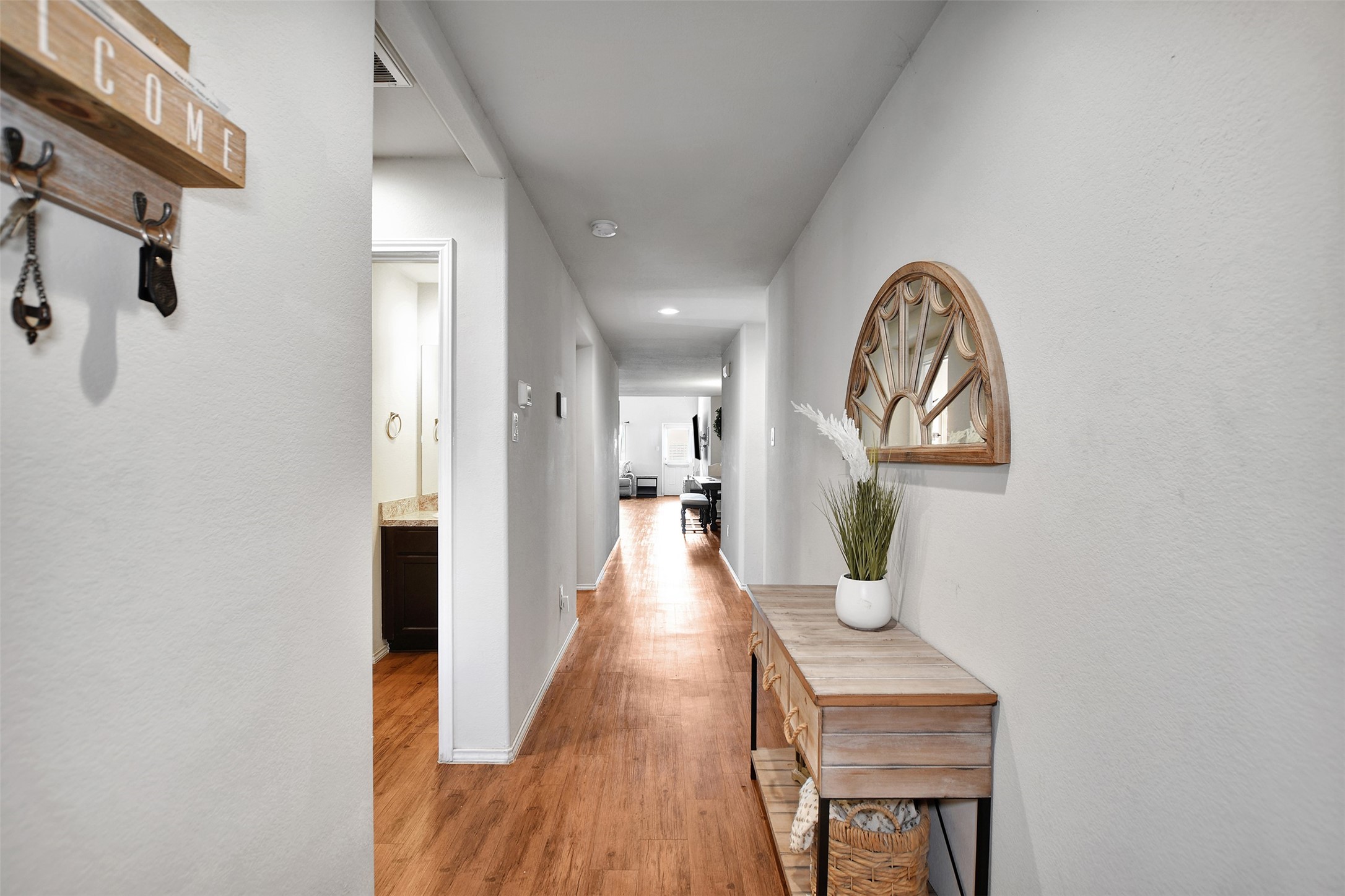 1022 Rancho Grande Drive Channelview, TX 77530 - Photo 7 of 36 a view of a hallway with wooden floor and dining room