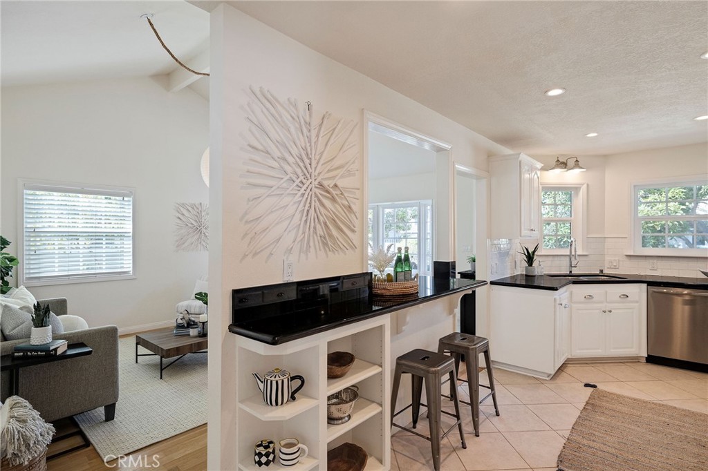 4914 Halison Street Torrance, CA 90503 - Photo 21 of 51 a kitchen with granite countertop a stove a sink a dining table and chairs