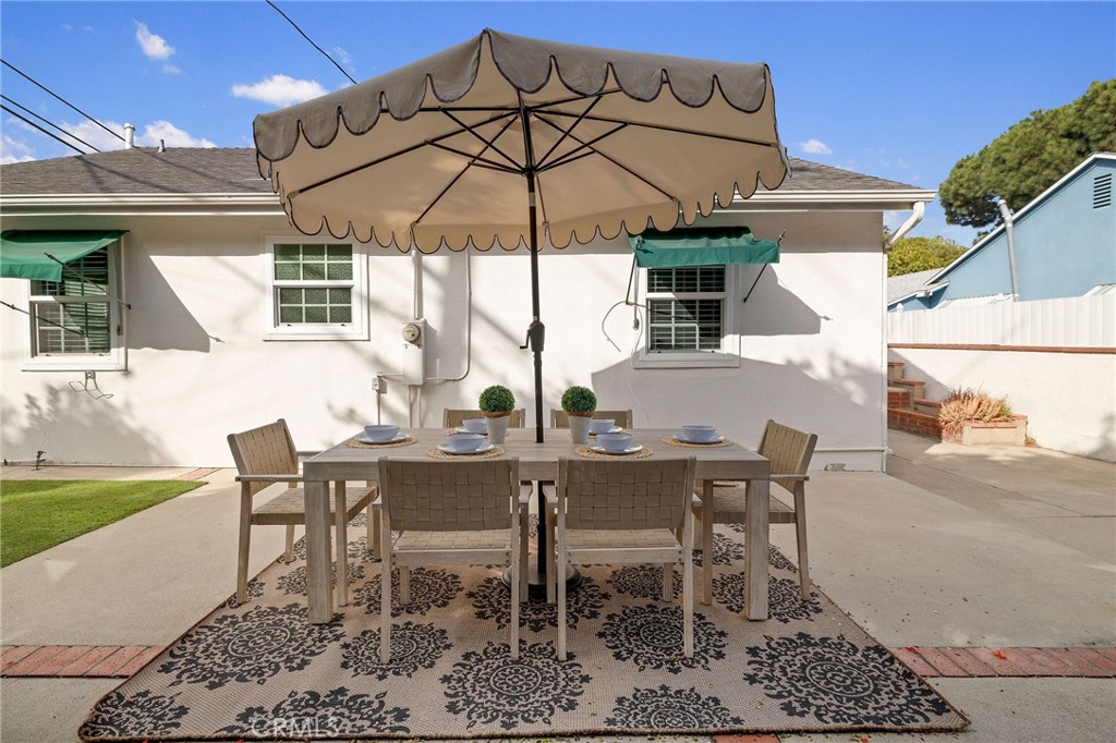 4914 Halison Street Torrance, CA 90503 - Photo 35 of 51 a view of a patio with a table and chairs under an umbrella