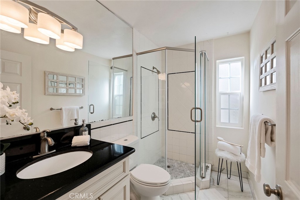 4914 Halison Street Torrance, CA 90503 - Photo 44 of 51 a bathroom with a sink a toilet a mirror a vanity and shower