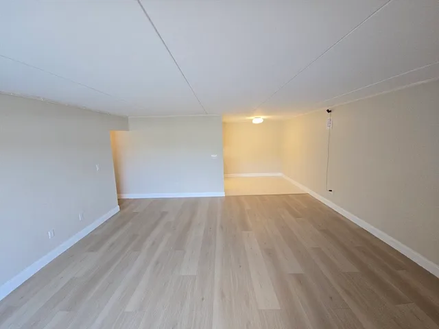 a view of an empty room and wooden floor