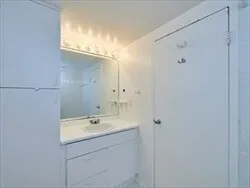 a bathroom with a shower sink and mirror