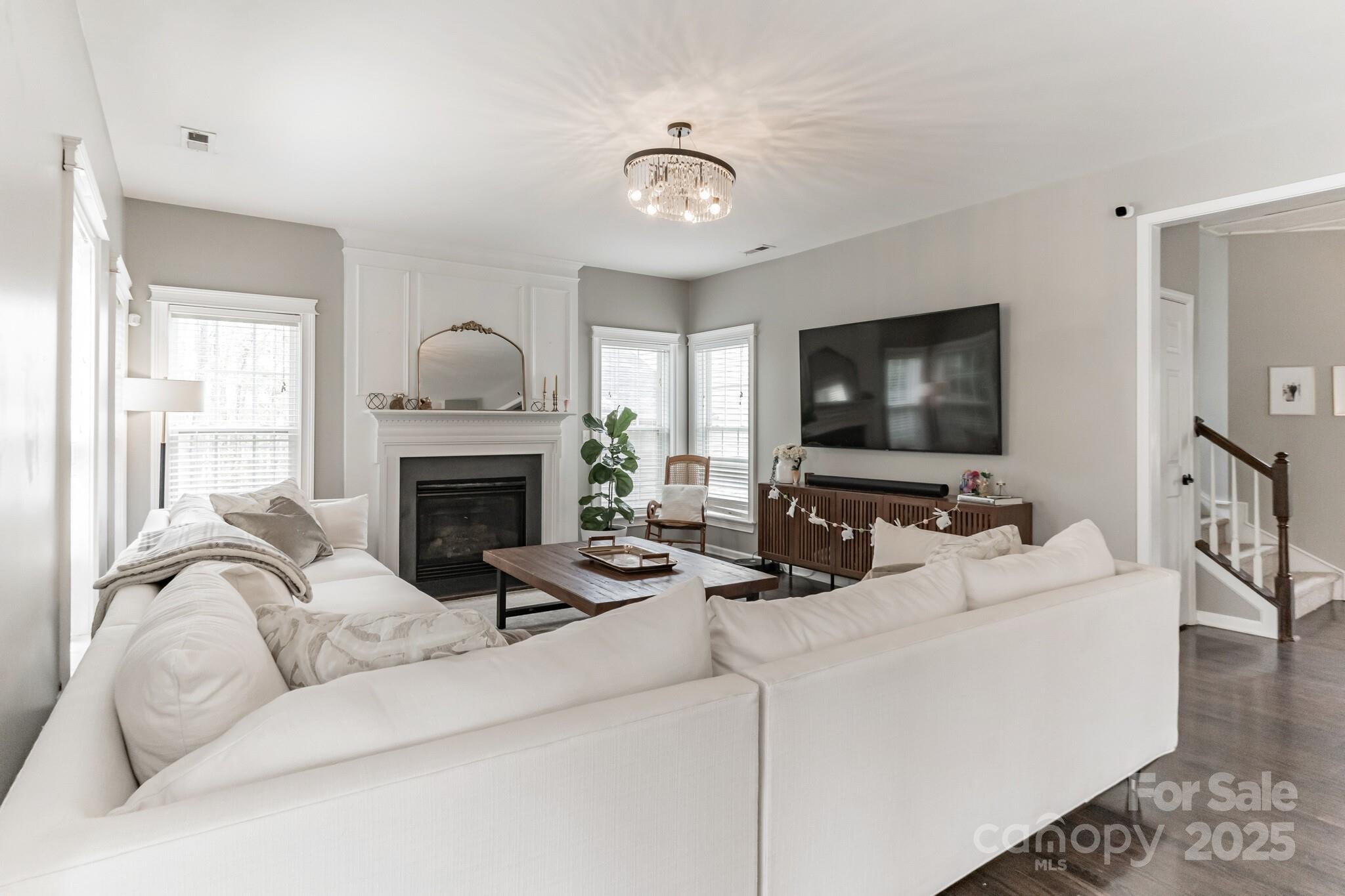 7215 Meyer Road Fort Mill, SC 29715 - Photo 11 of 35 a living room with furniture a flat screen tv and a fireplace