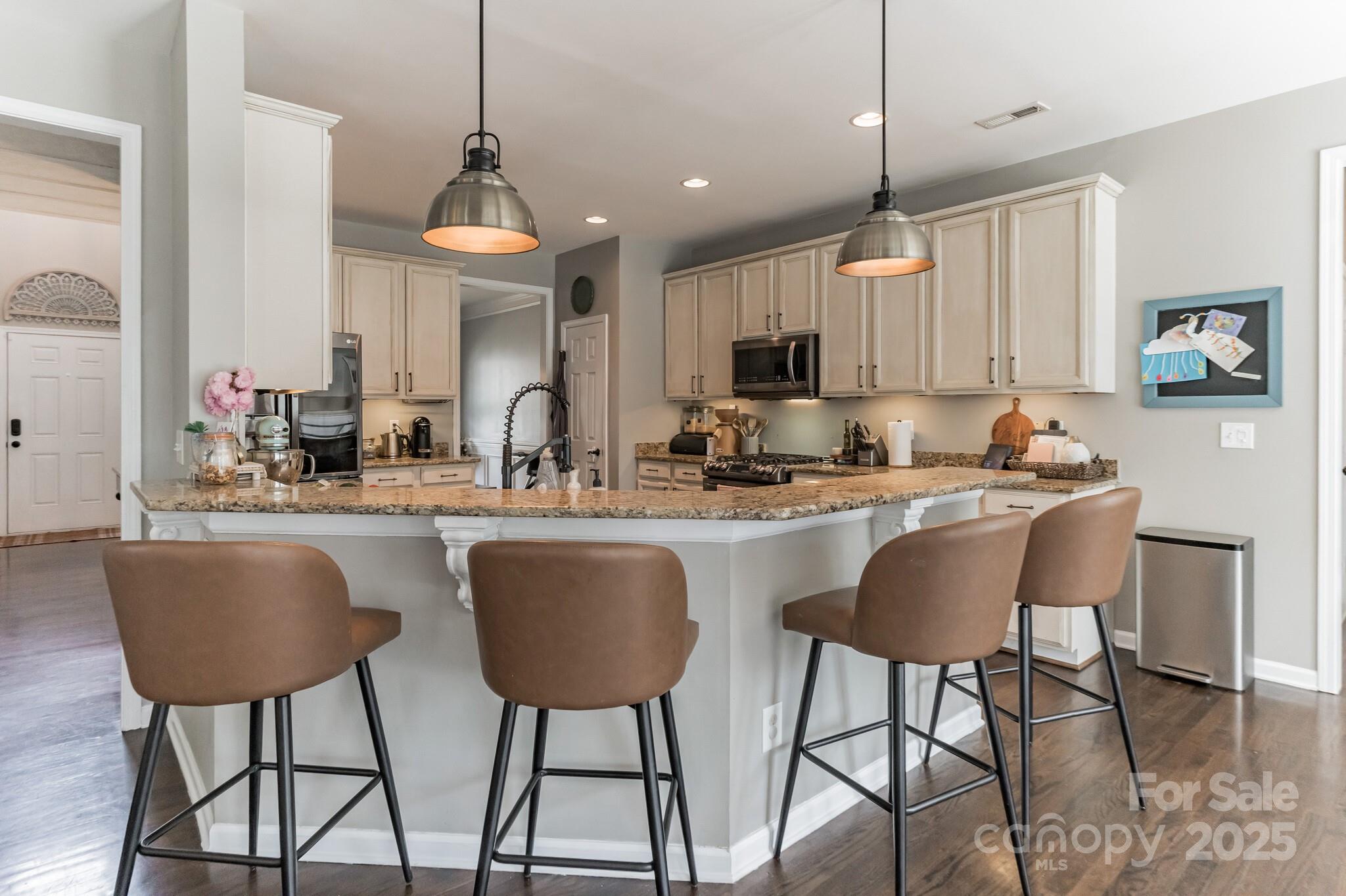 7215 Meyer Road Fort Mill, SC 29715 - Photo 14 of 35 a kitchen with kitchen island a dining table chairs and a sink