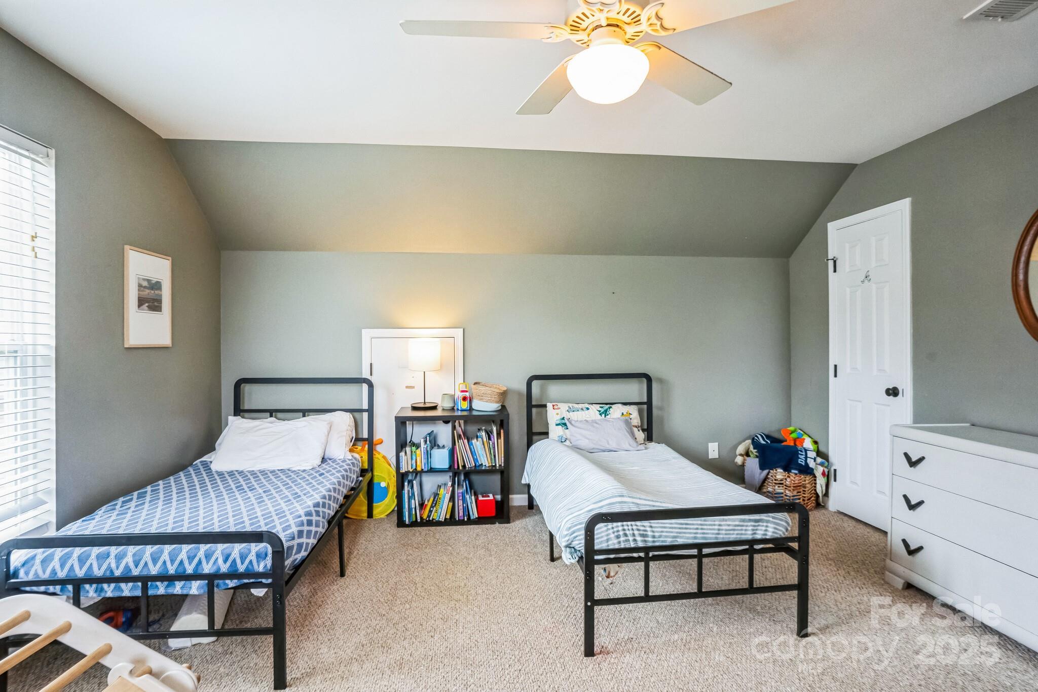 7215 Meyer Road Fort Mill, SC 29715 - Photo 26 of 35 a bedroom with furniture and a chandelier