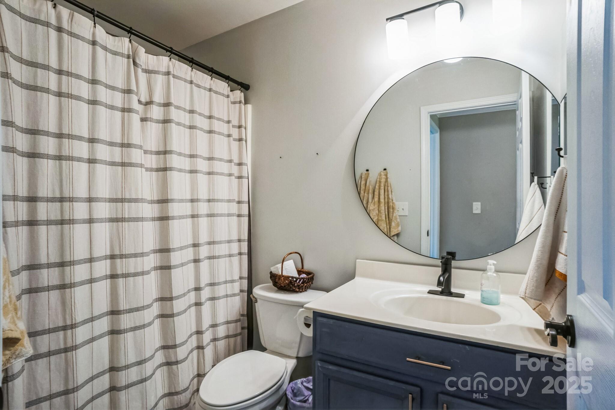 7215 Meyer Road Fort Mill, SC 29715 - Photo 28 of 35 a bathroom with a sink toilet a mirror and shower curtain