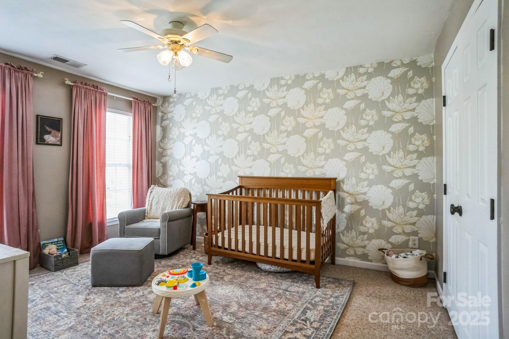 7215 Meyer Road Fort Mill, SC 29715 - Photo 29 of 35 a bedroom with a bed and a chandelier