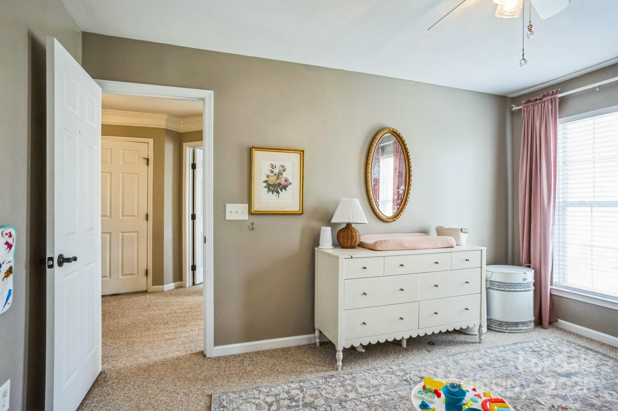 7215 Meyer Road Fort Mill, SC 29715 - Photo 30 of 35 a room with painting on the wall a dresser and a window