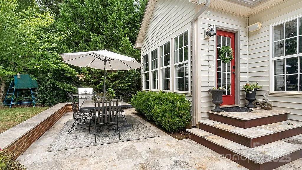 7215 Meyer Road Fort Mill, SC 29715 - Photo 6 of 35 a view of a patio with a table and chairs under an umbrella