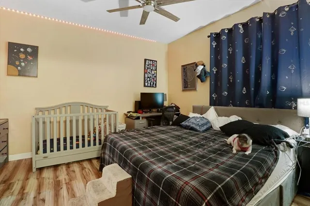 a bedroom with a bed and wooden floor