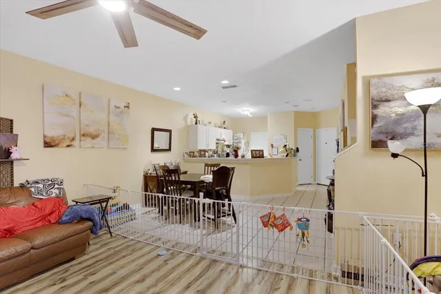 a living room with furniture and kitchen view
