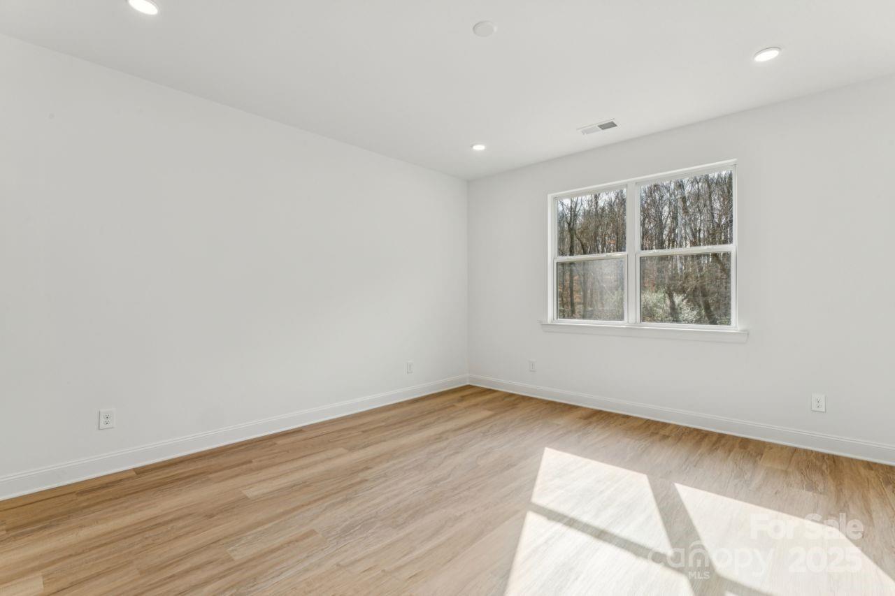 2605 Easter Street Maiden, NC 28650 - Photo 12 of 36 an empty room with wooden floor and windows
