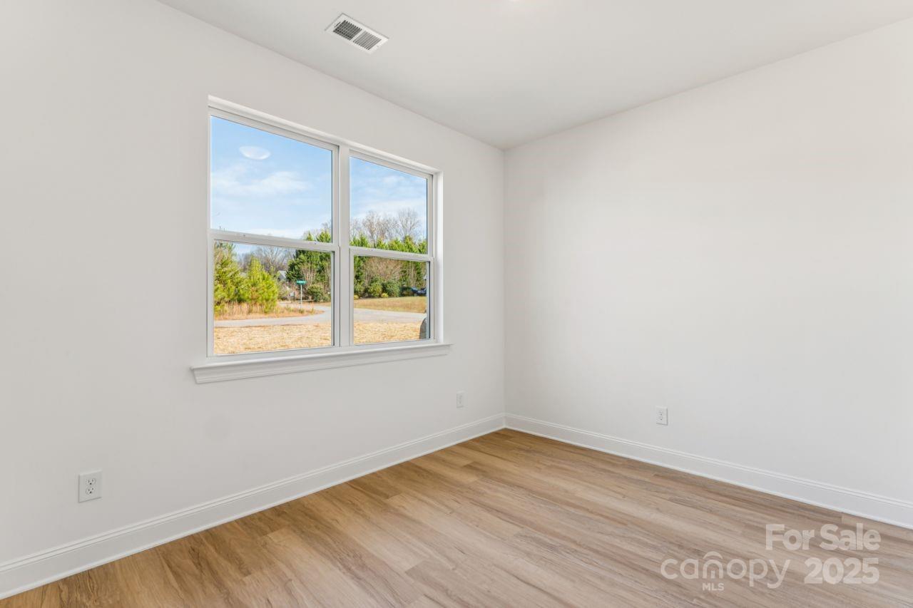 2605 Easter Street Maiden, NC 28650 - Photo 19 of 36 an empty room with wooden floor and a window