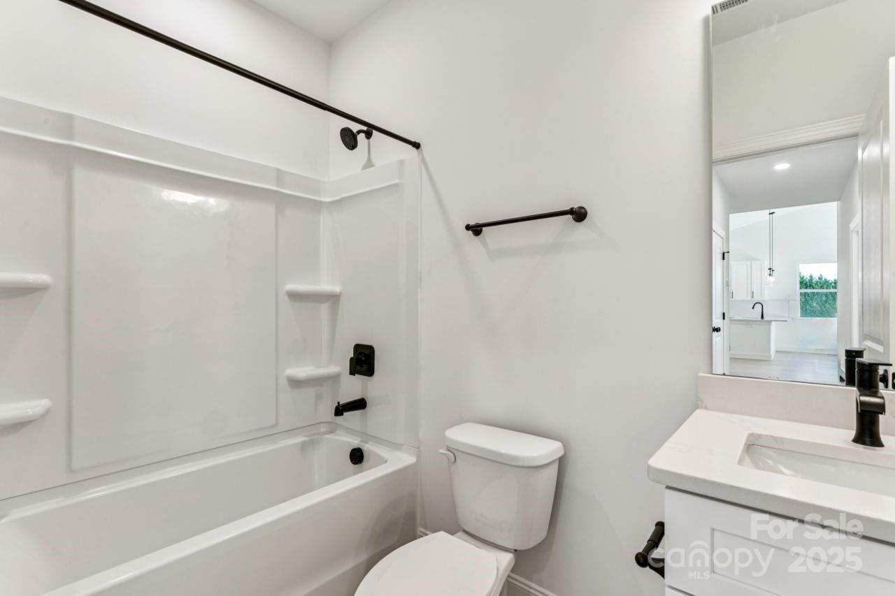 2605 Easter Street Maiden, NC 28650 - Photo 21 of 36 a bathroom with a toilet a sink and a bathtub