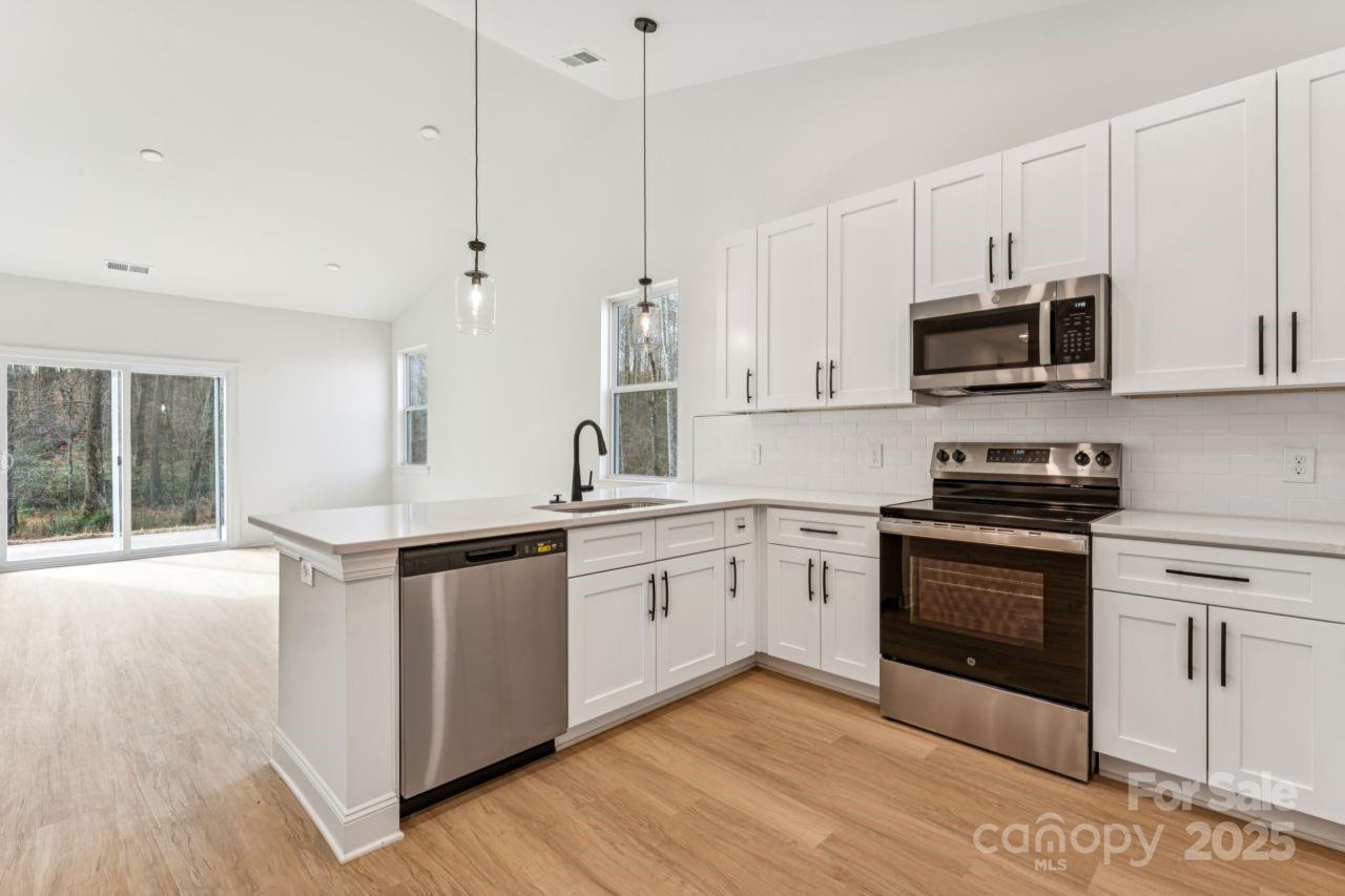 2605 Easter Street Maiden, NC 28650 - Photo 3 of 36 a kitchen with stainless steel appliances granite countertop a stove and a sink