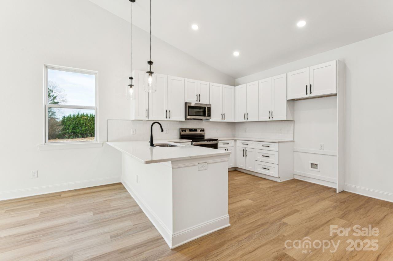 2605 Easter Street Maiden, NC 28650 - Photo 5 of 36 a kitchen with stainless steel appliances granite countertop a stove a sink and a refrigerator