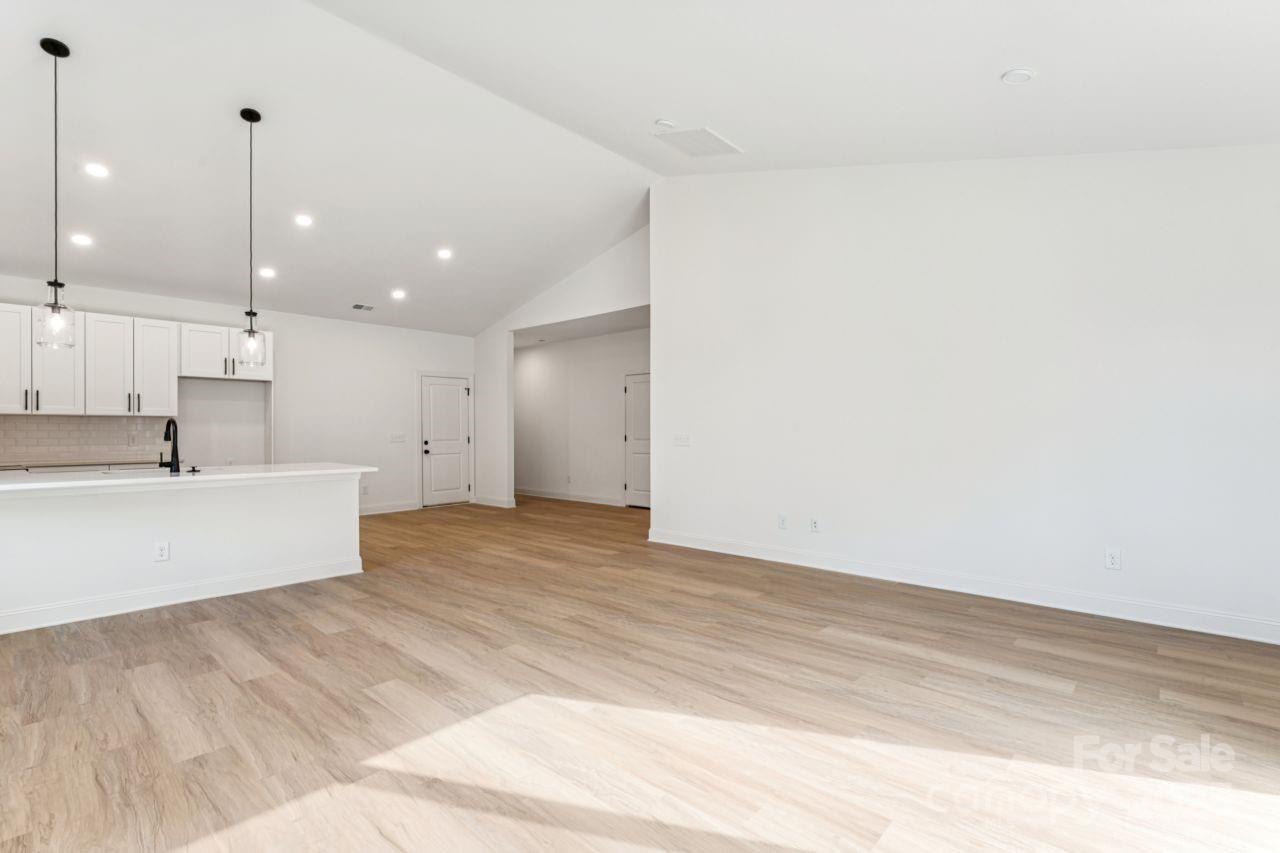2605 Easter Street Maiden, NC 28650 - Photo 7 of 36 a view of an empty room with kitchen and windows