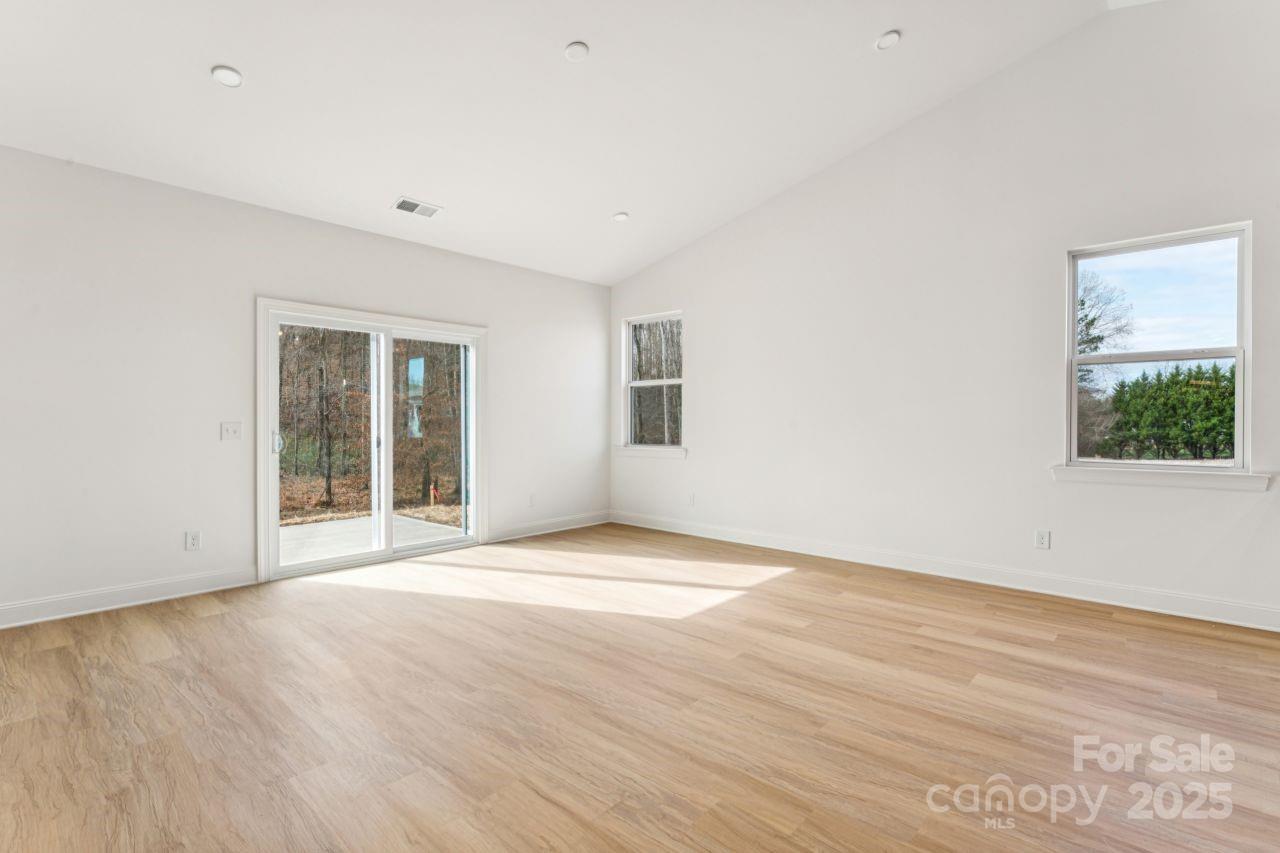2605 Easter Street Maiden, NC 28650 - Photo 9 of 36 a view of an empty room with wooden floor and a window
