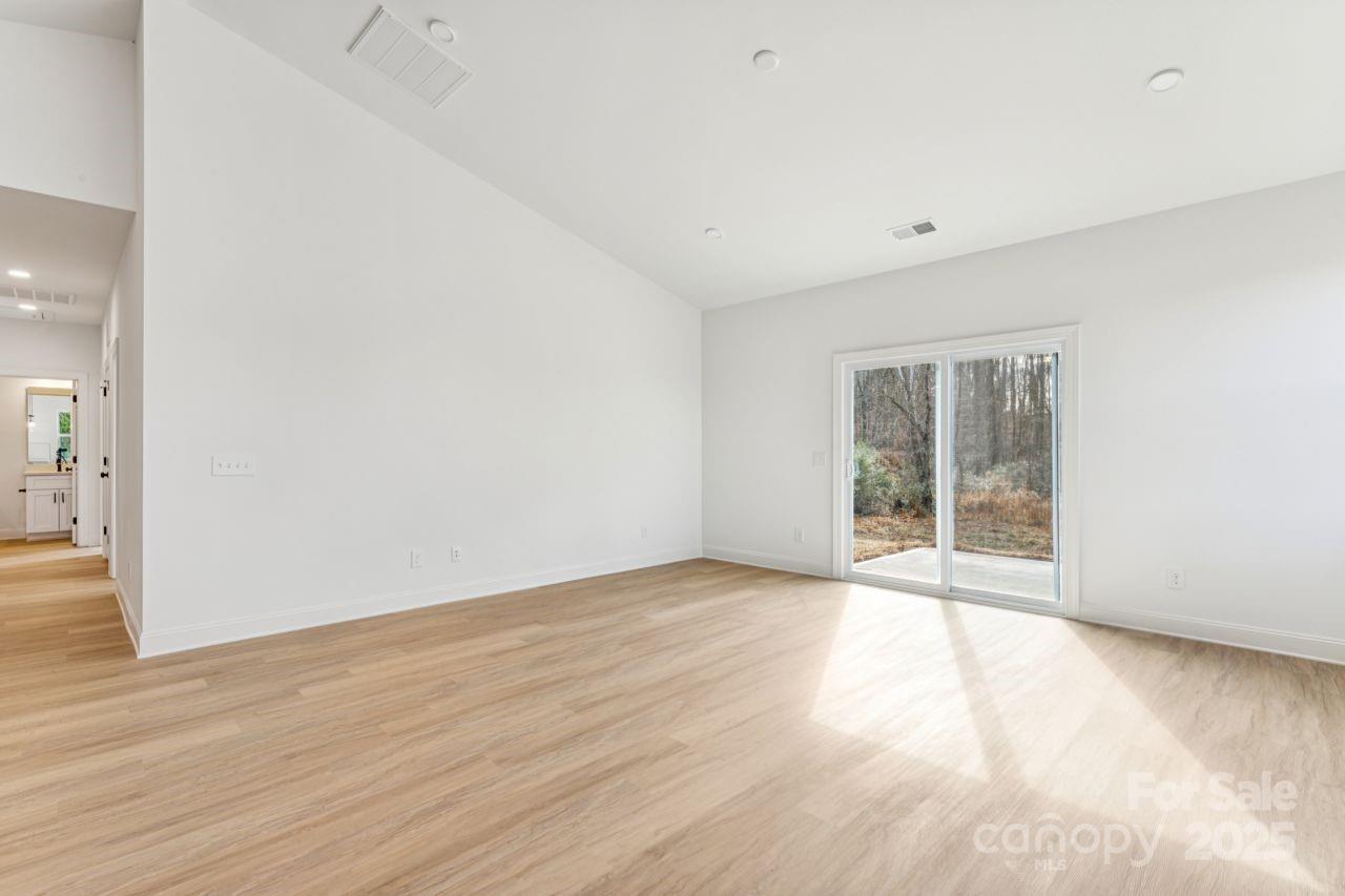 2605 Easter Street Maiden, NC 28650 - Photo 10 of 36 a view of an empty room with wooden floor and a window