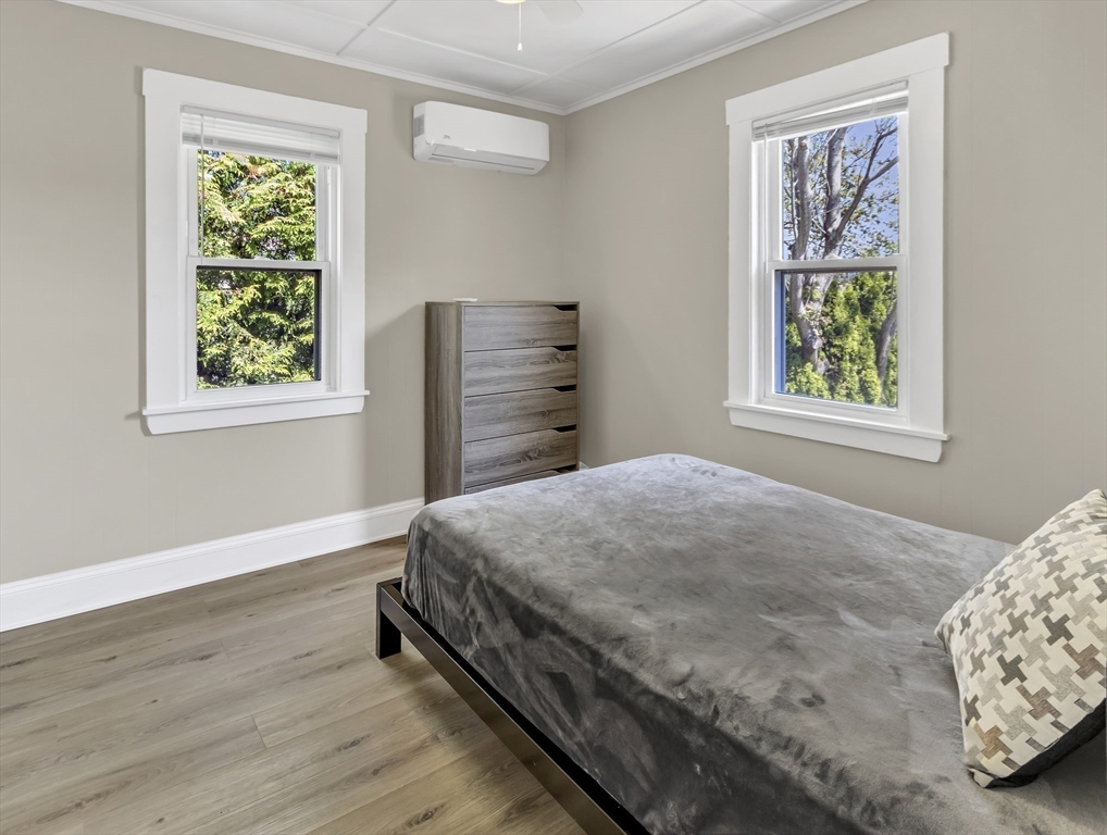 52 H Street Hull, MA 02045 - Photo 11 of 41 a bedroom with a bed and a window