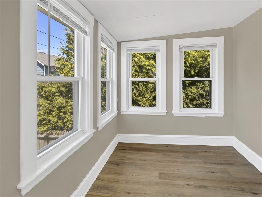 52 H Street Hull, MA 02045 - Photo 13 of 41 a view of an empty room with wooden floor and a window