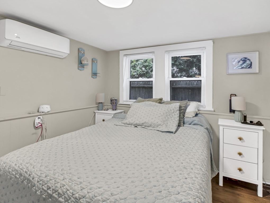 52 H Street Hull, MA 02045 - Photo 23 of 41 a bedroom with a bed and a window