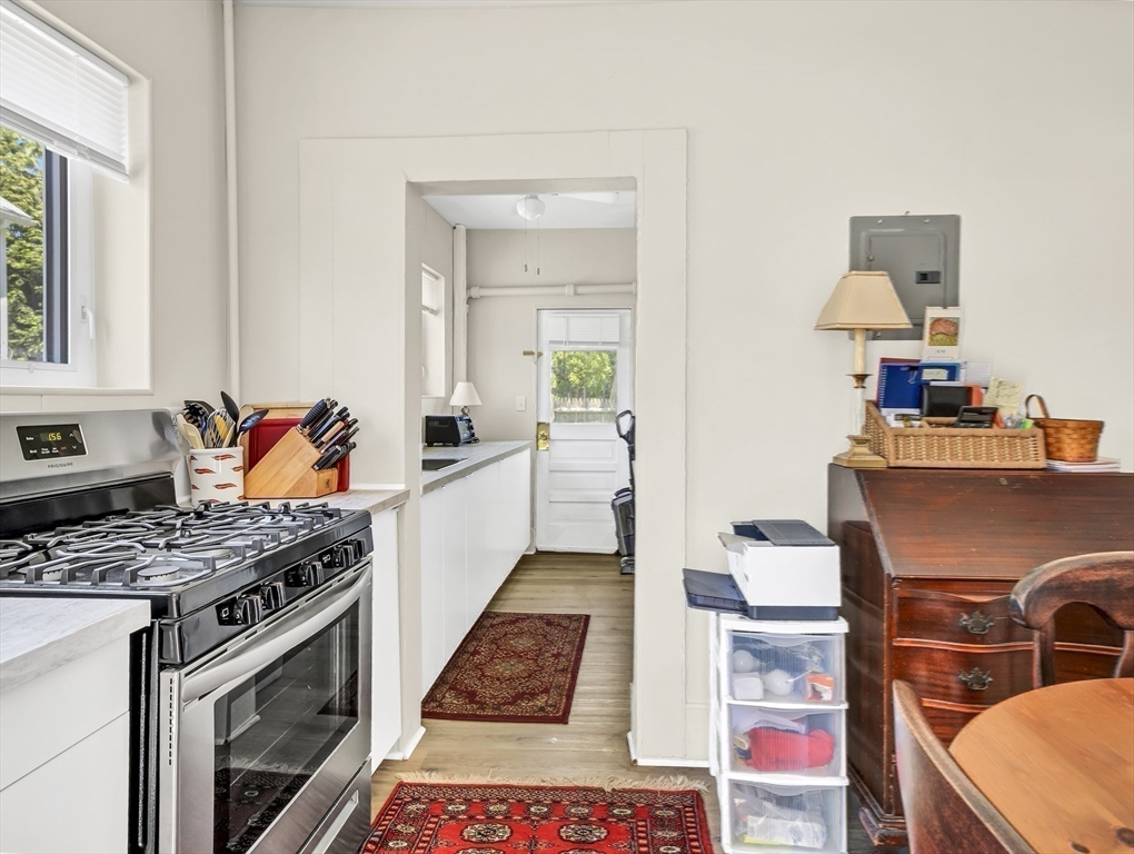52 H Street Hull, MA 02045 - Photo 31 of 41 a kitchen with stainless steel appliances granite countertop a stove a sink and a microwave