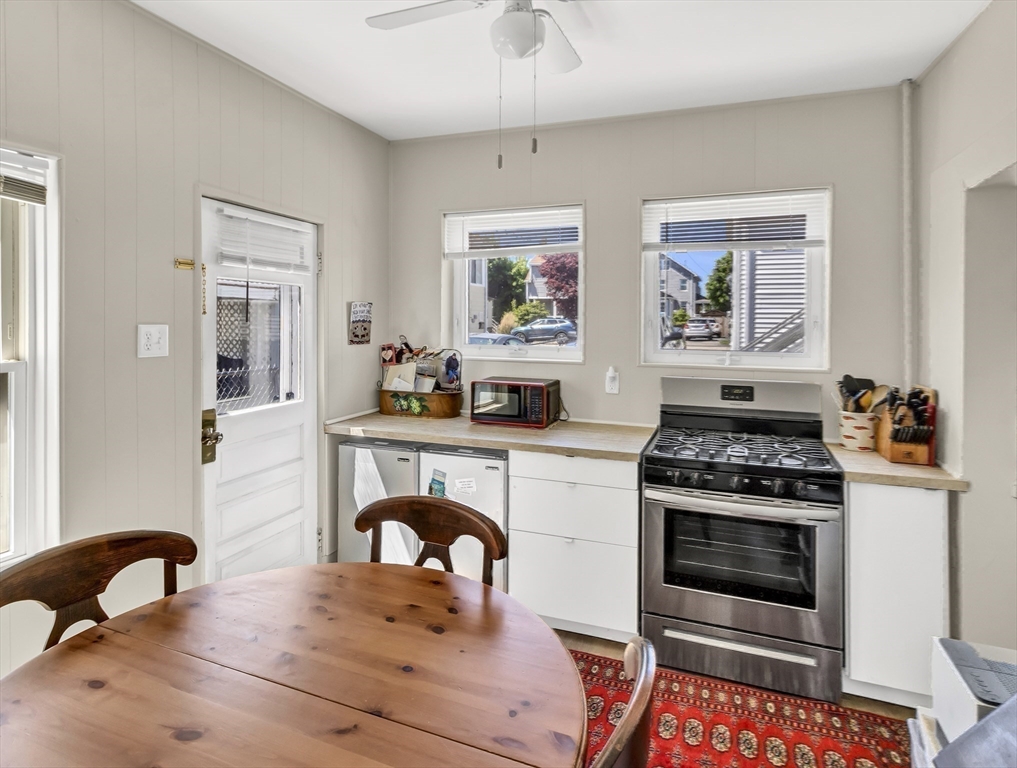 52 H Street Hull, MA 02045 - Photo 32 of 41 a kitchen with a stove a sink and a refrigerator