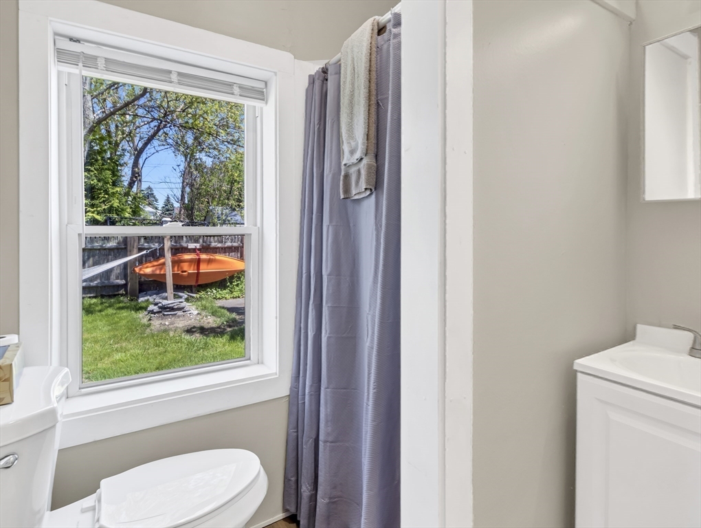 52 H Street Hull, MA 02045 - Photo 36 of 41 a bathroom with a toilet a sink and a window