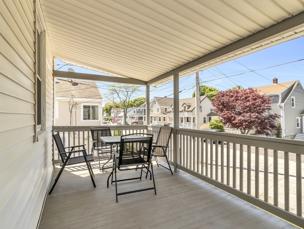 52 H Street Hull, MA 02045 - Photo 4 of 41 a view of a patio with a table and chairs and wooden floor