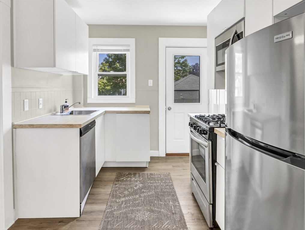 52 H Street Hull, MA 02045 - Photo 6 of 41 a room with a sink window and washer