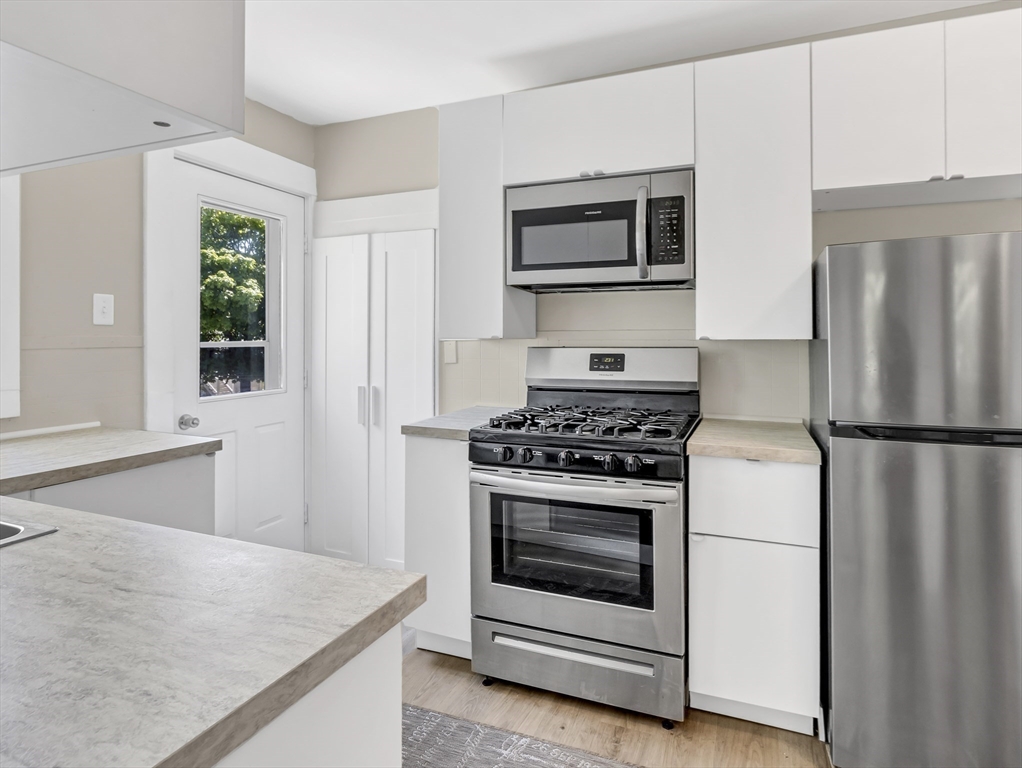 52 H Street Hull, MA 02045 - Photo 7 of 41 a white refrigerator freezer sitting in a kitchen