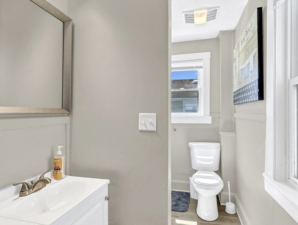 52 H Street Hull, MA 02045 - Photo 10 of 41 a bathroom with a sink a toilet and a window