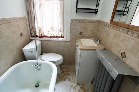 a view of entryway and bedroom with a chair