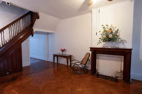 a view of a livingroom with furniture and staircase