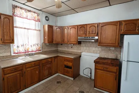 a kitchen with stainless steel appliances a sink and a window