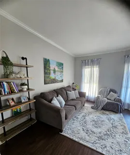 a living room with furniture and a book shelf